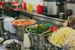 Colorful array of Korean dishes in a bustling Seoul street food market.